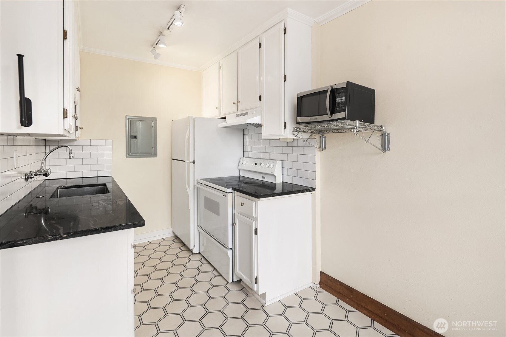 1631 16th Avenue, Unit 309 Seattle, WA 98122 - Photo 10 of 23 a kitchen with stainless steel appliances a stove a sink and a refrigerator