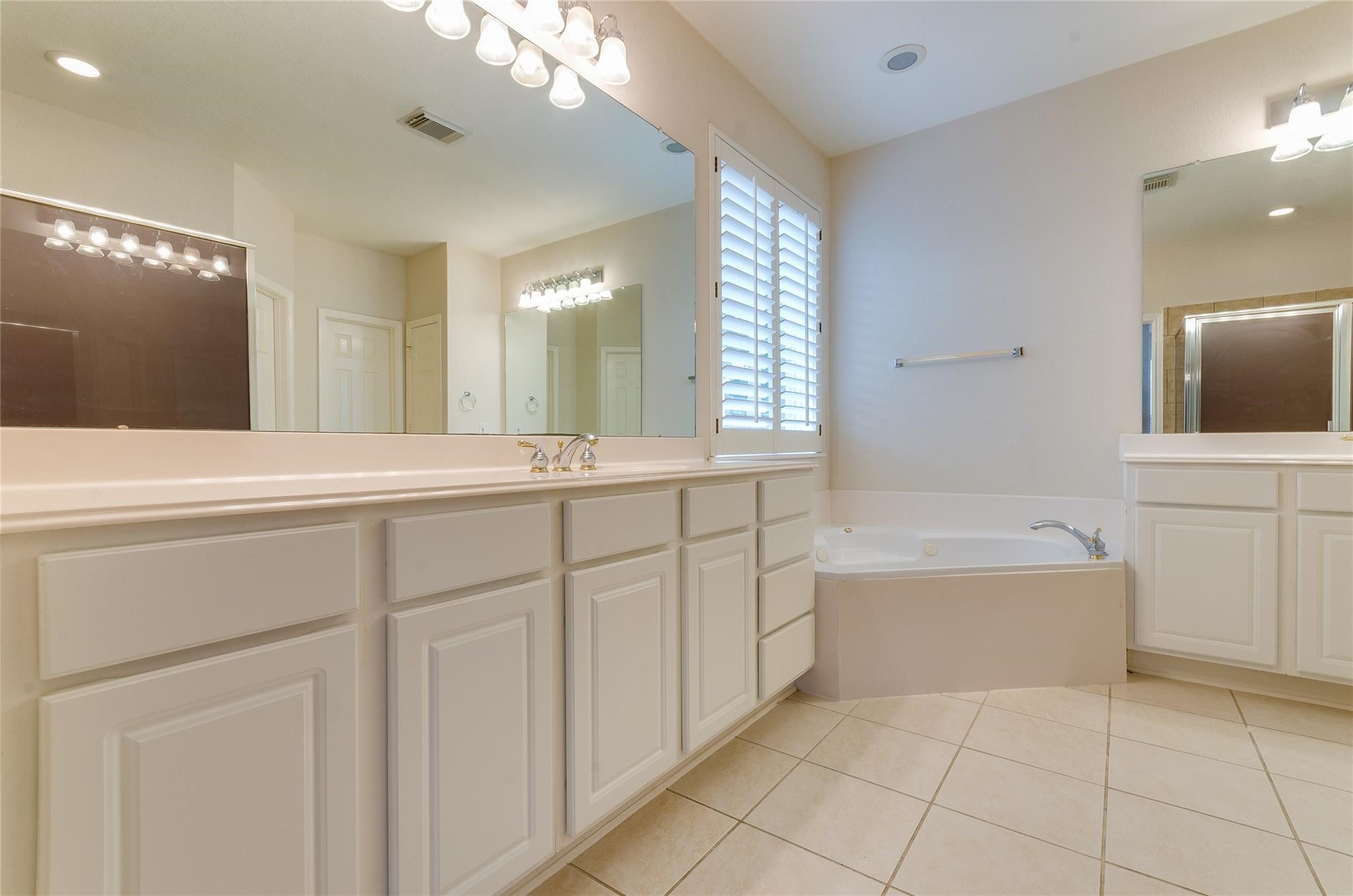 4019 Angel Spring Drive Sugar Land, TX 77479 - Photo 25 of 50 a spacious bathroom with a tub sink and mirror