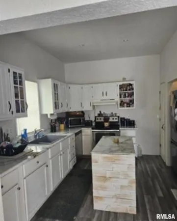 a kitchen with sink cabinets and stove