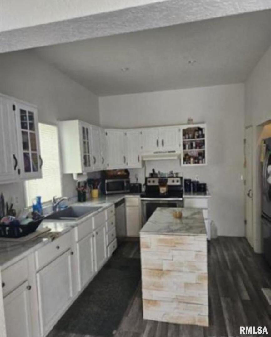 701 3rd Street Seaton, IL 61476 - Photo 4 of 10 a kitchen with sink cabinets and stove