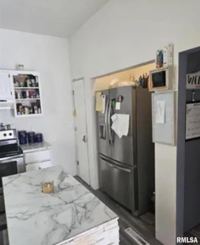a kitchen with stainless steel appliances a refrigerator and a stove top oven