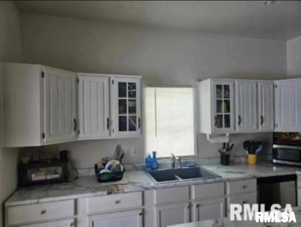 701 3rd Street Seaton, IL 61476 - Photo 6 of 10 a kitchen with stainless steel appliances granite countertop white cabinets sink and dishwasher