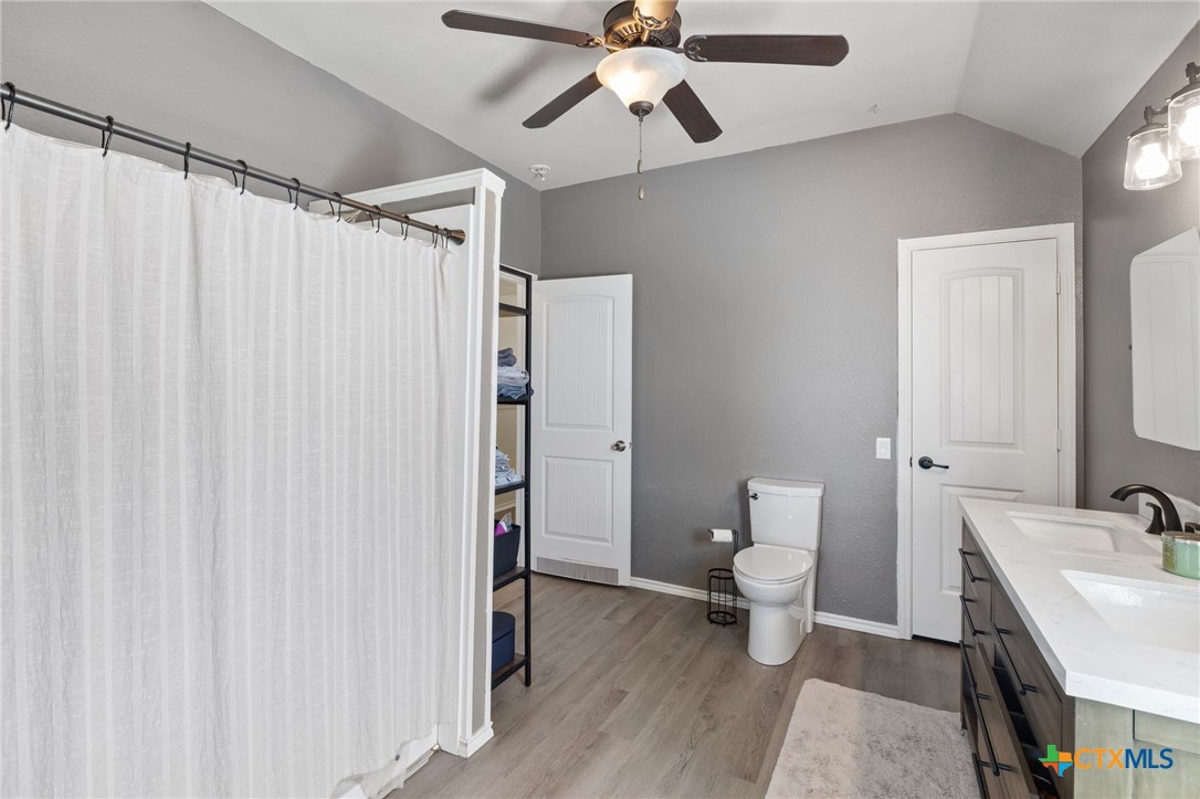 10113 Copper Ridge Cove Austin, TX 78747 - Photo 19 of 32 a bathroom with a sink a toilet and shower