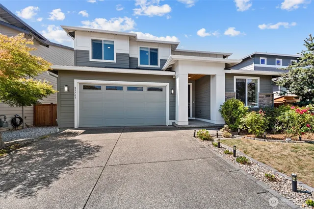 a front view of a house with a yard and garage