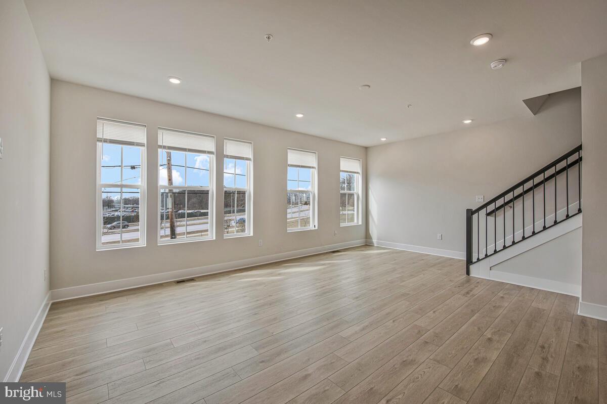 7268 Contee Road Laurel, MD 20707 - Photo 11 of 42 a view of an empty room with wooden floor and a window