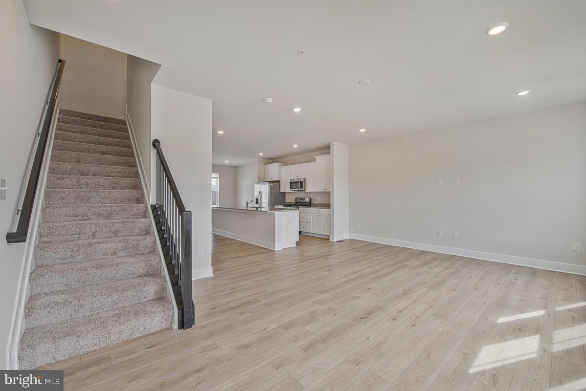 7268 Contee Road Laurel, MD 20707 - Photo 13 of 42 a view of a kitchen with wooden floor and stairs