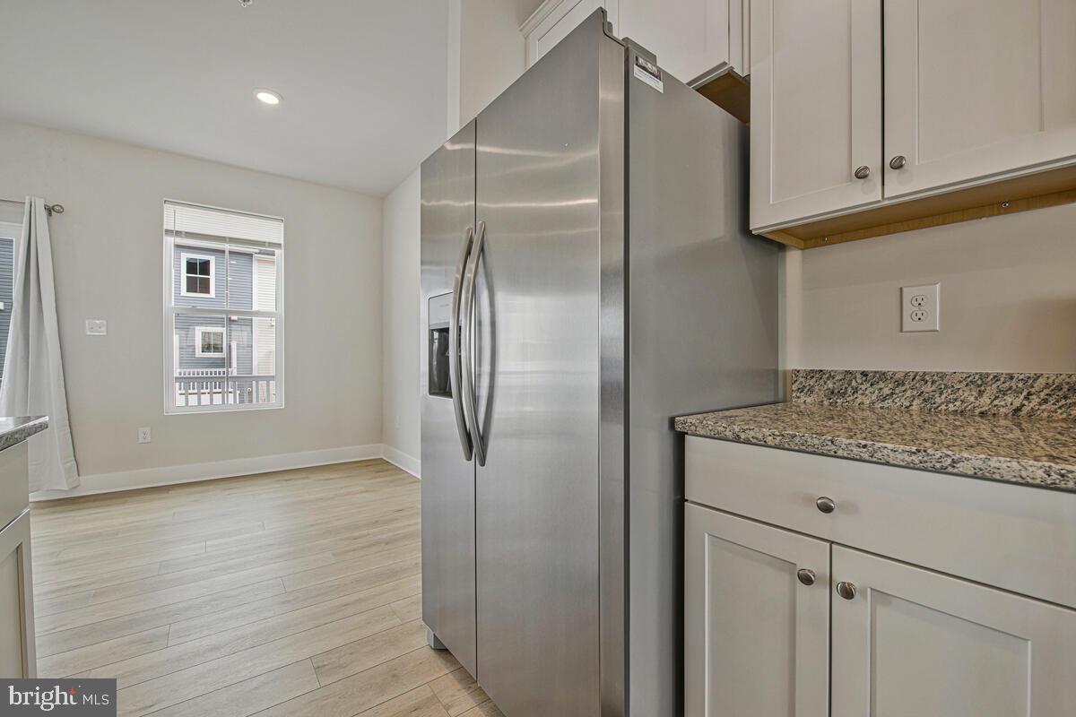7268 Contee Road Laurel, MD 20707 - Photo 19 of 42 a kitchen with a refrigerator and cabinets
