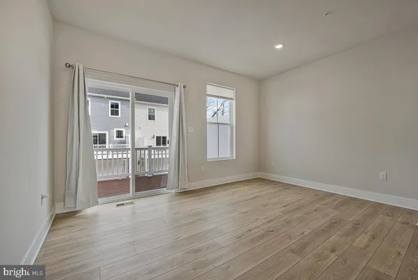 a view of a livingroom with wooden floor and a window