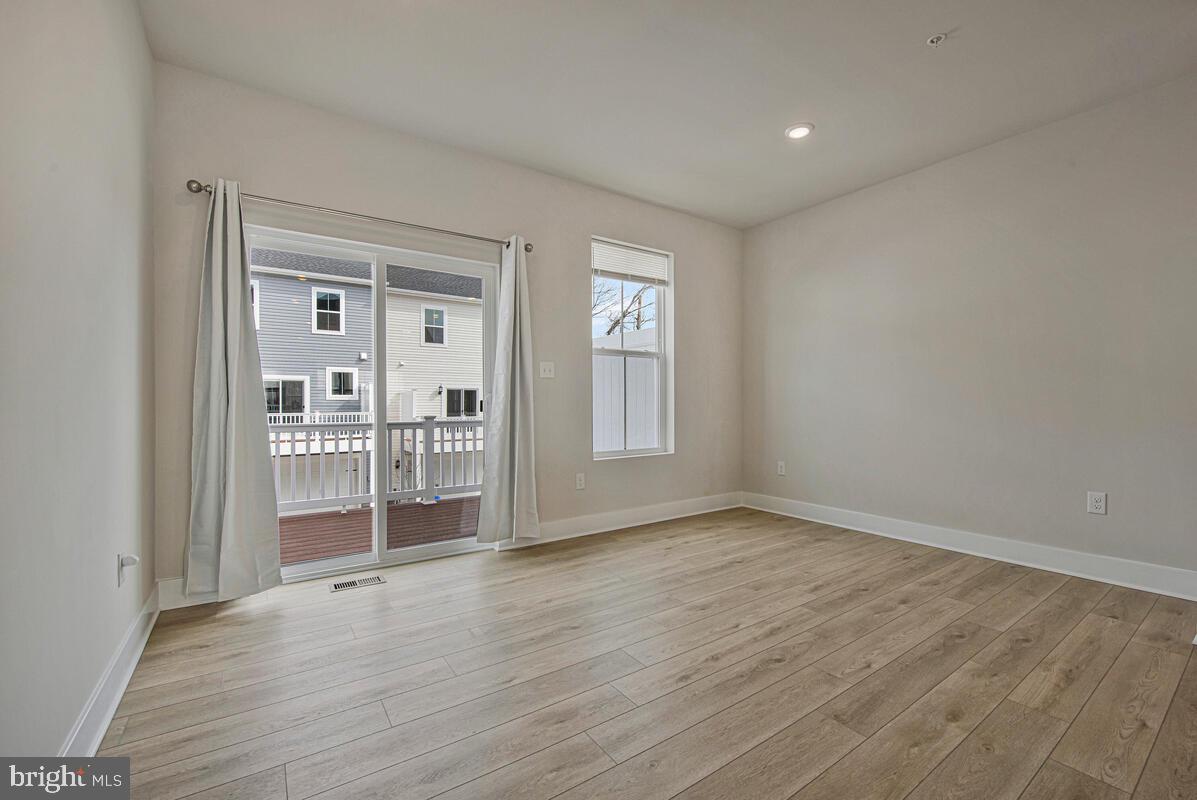 7268 Contee Road Laurel, MD 20707 - Photo 22 of 42 a view of a livingroom with wooden floor and a window