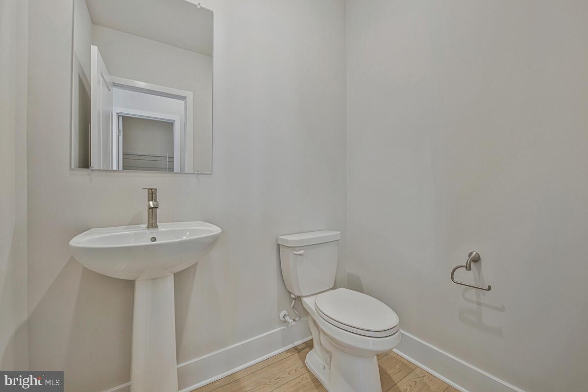 7268 Contee Road Laurel, MD 20707 - Photo 25 of 42 a bathroom with a toilet sink and mirror