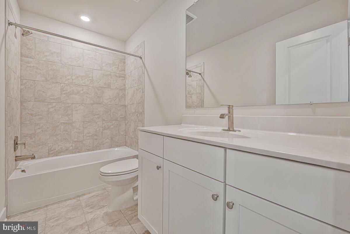 7268 Contee Road Laurel, MD 20707 - Photo 30 of 42 a bathroom with a sink a toilet and shower
