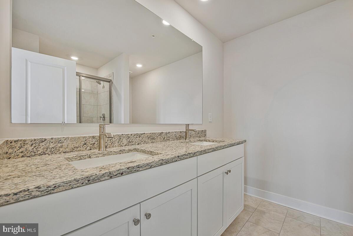 7268 Contee Road Laurel, MD 20707 - Photo 34 of 42 a bathroom with a granite countertop sink and a mirror