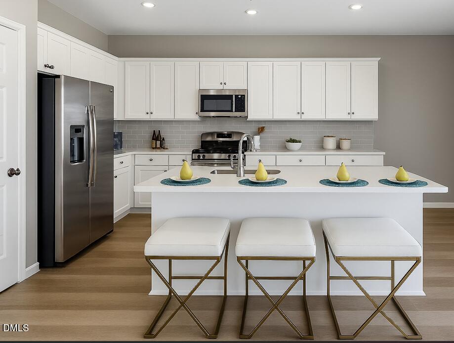 a kitchen with stainless steel appliances a stove refrigerator sink and cabinets