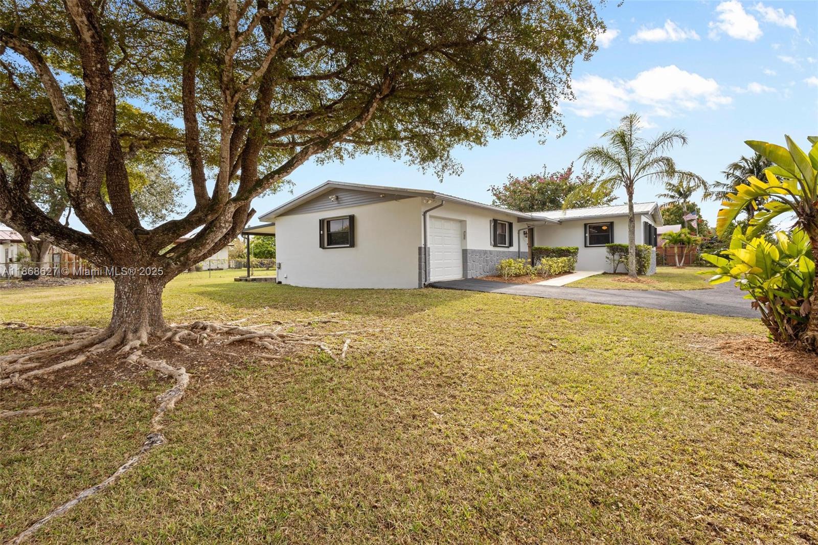 27661 Southwest 162nd Court Homestead, FL 33031 - Photo 12 of 60 a view of a house with a yard