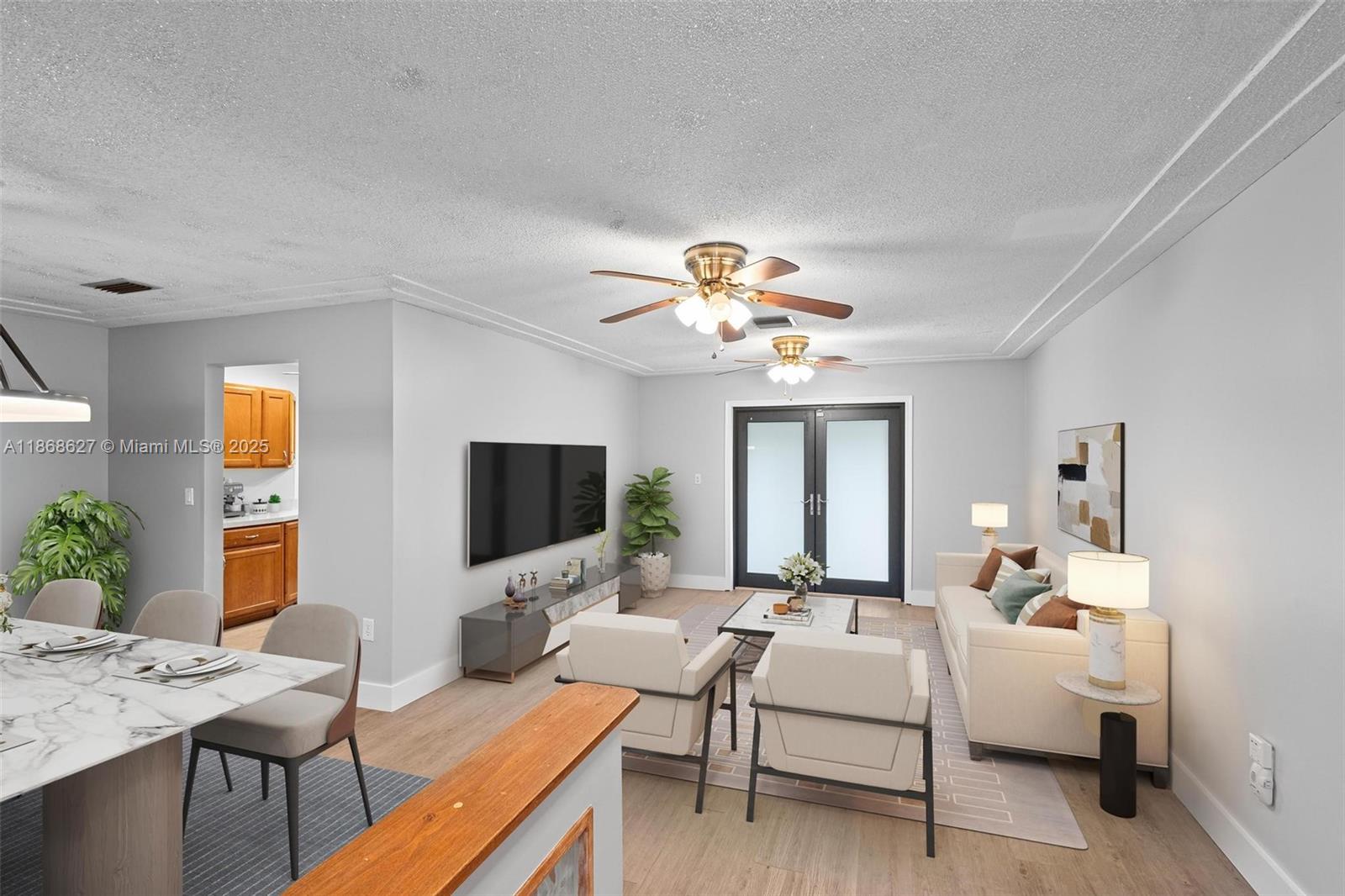 27661 Southwest 162nd Court Homestead, FL 33031 - Photo 19 of 60 a living room with furniture a chandelier and a flat screen tv