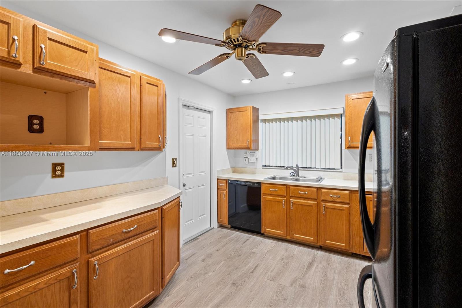27661 Southwest 162nd Court Homestead, FL 33031 - Photo 22 of 60 a kitchen with stainless steel appliances granite countertop a refrigerator a sink dishwasher a stove and white countertops with wooden floor