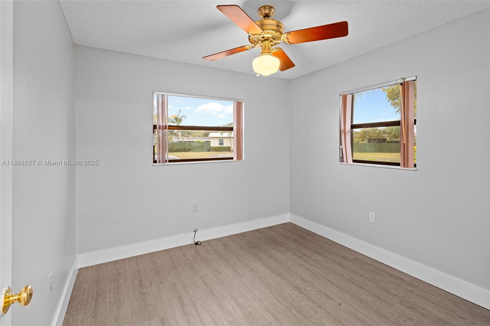 27661 Southwest 162nd Court Homestead, FL 33031 - Photo 29 of 60 an empty room with a window and a ceiling fan