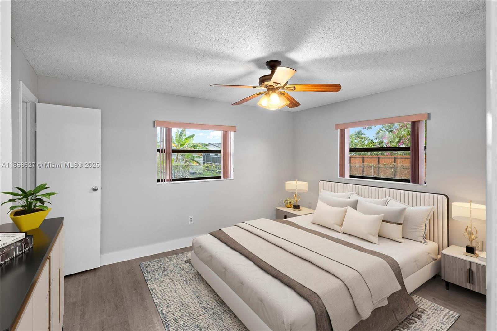 27661 Southwest 162nd Court Homestead, FL 33031 - Photo 39 of 60 a bedroom with a bed and a chandelier