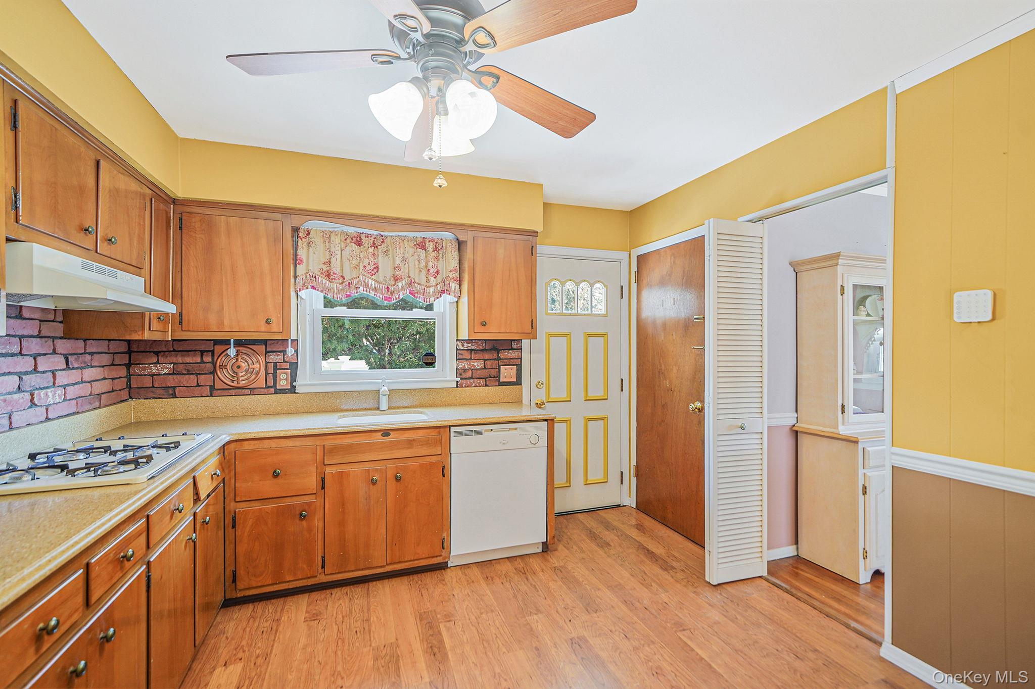 2009 Newbridge Road Bellmore, NY 11710 - Photo 12 of 24 a kitchen with stainless steel appliances granite countertop a hardwood floor sink and window