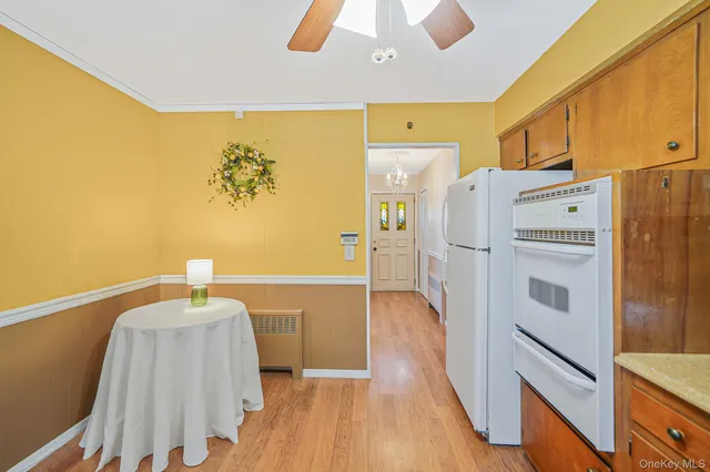 a kitchen with stainless steel appliances a refrigerator and a chandelier