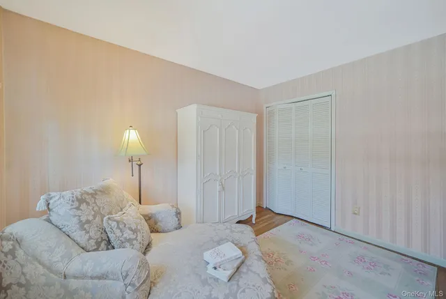 a bedroom with furniture and a lamp