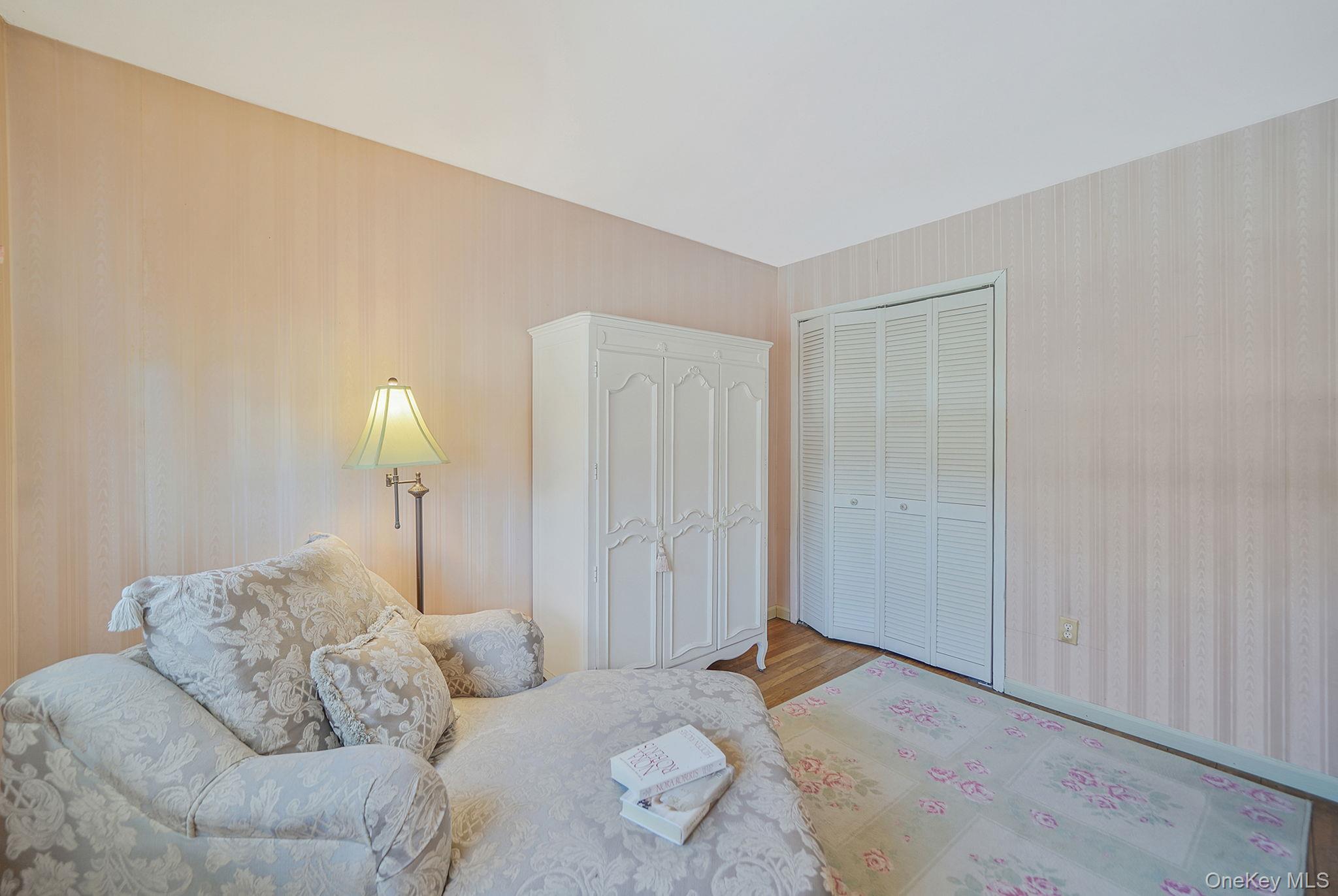 2009 Newbridge Road Bellmore, NY 11710 - Photo 18 of 24 a bedroom with furniture and a lamp
