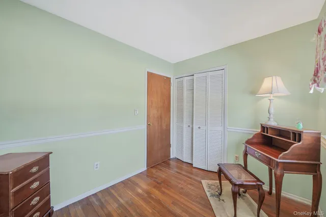 a bedroom with a bed and a lamp on table