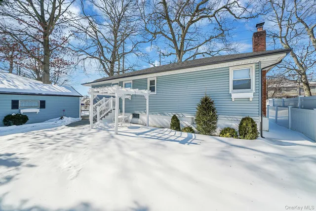 a view of a house with snow on the road