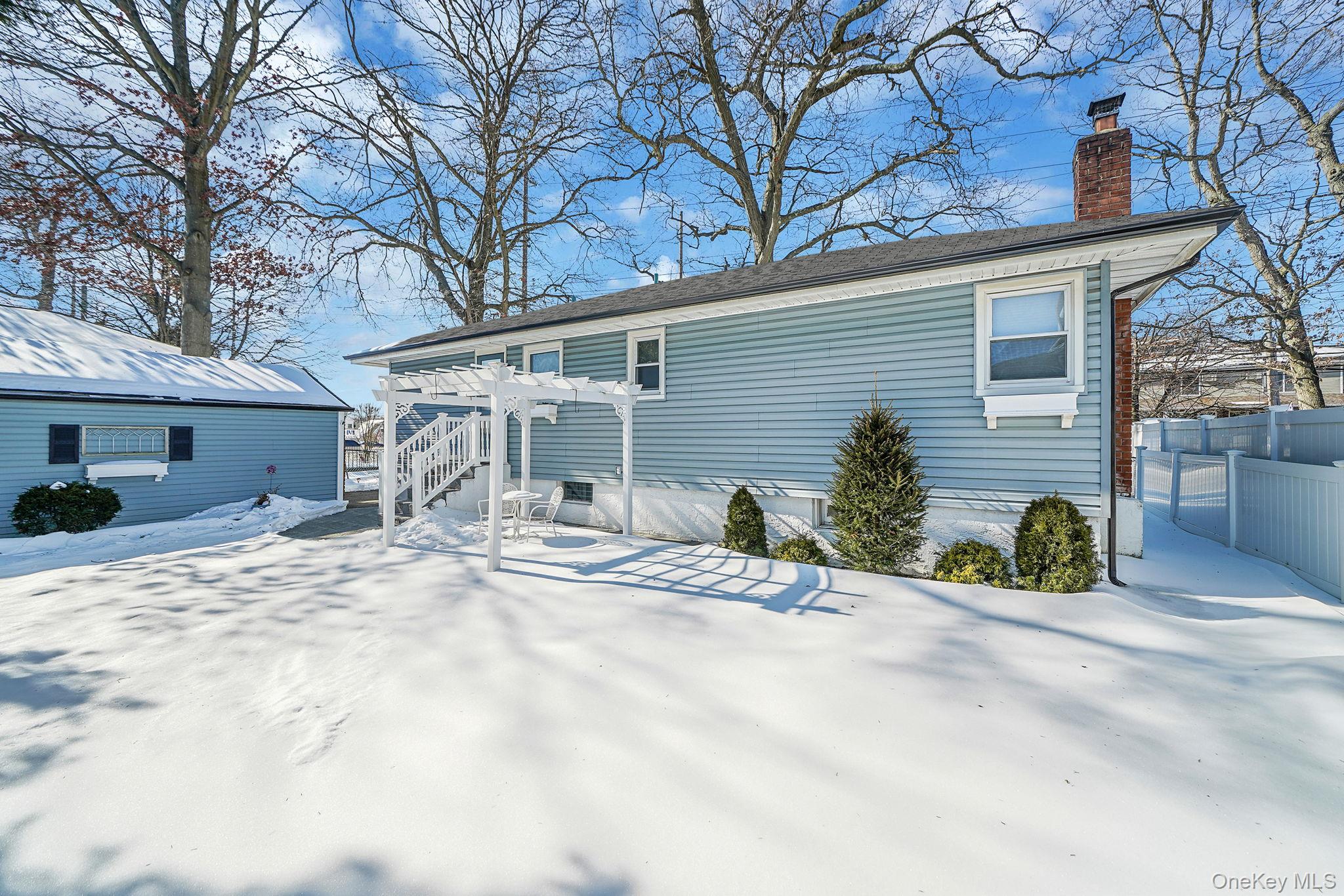 2009 Newbridge Road Bellmore, NY 11710 - Photo 6 of 24 a view of a house with snow on the road