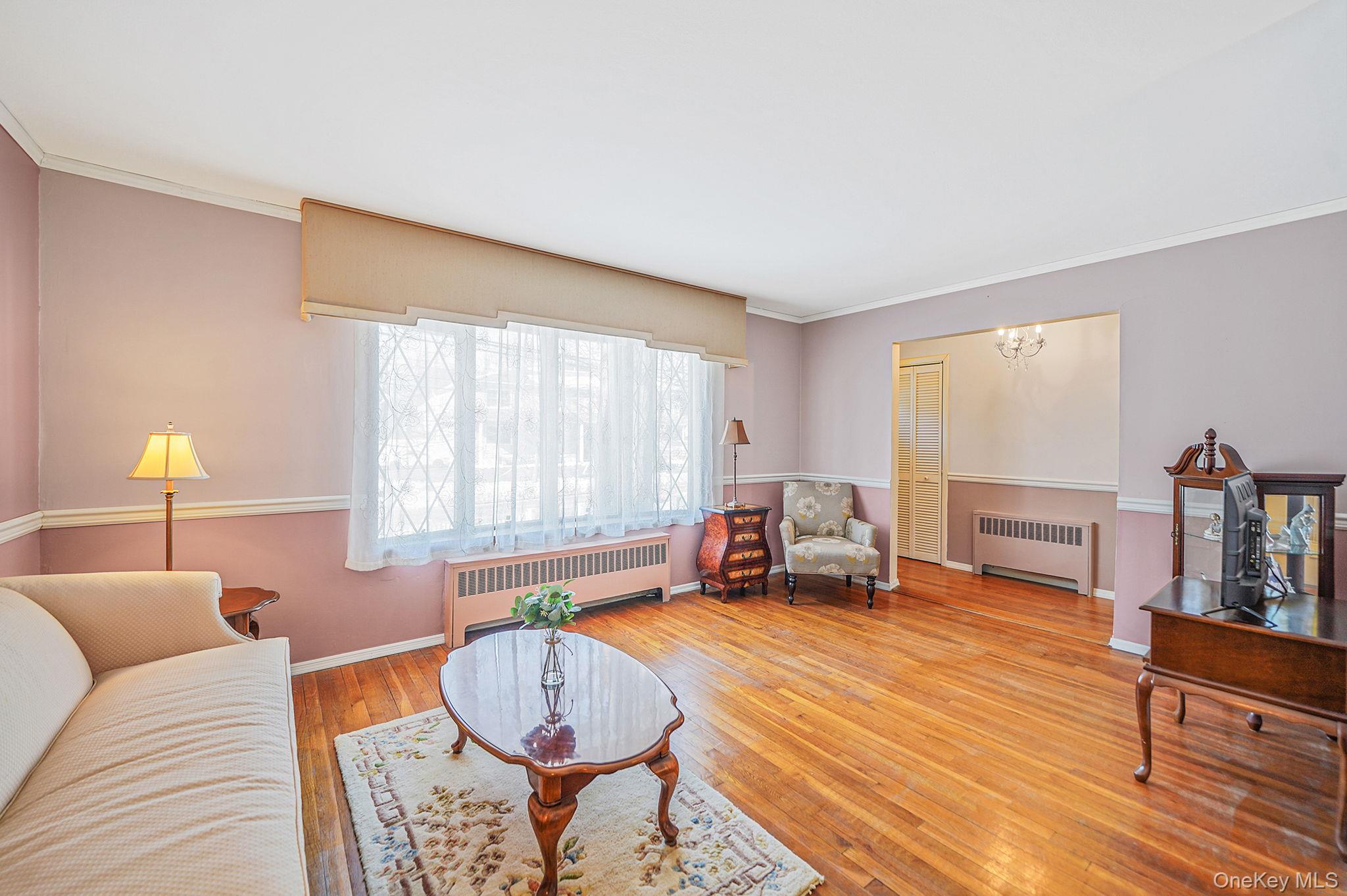 2009 Newbridge Road Bellmore, NY 11710 - Photo 9 of 24 a bedroom with furniture and a wooden floor