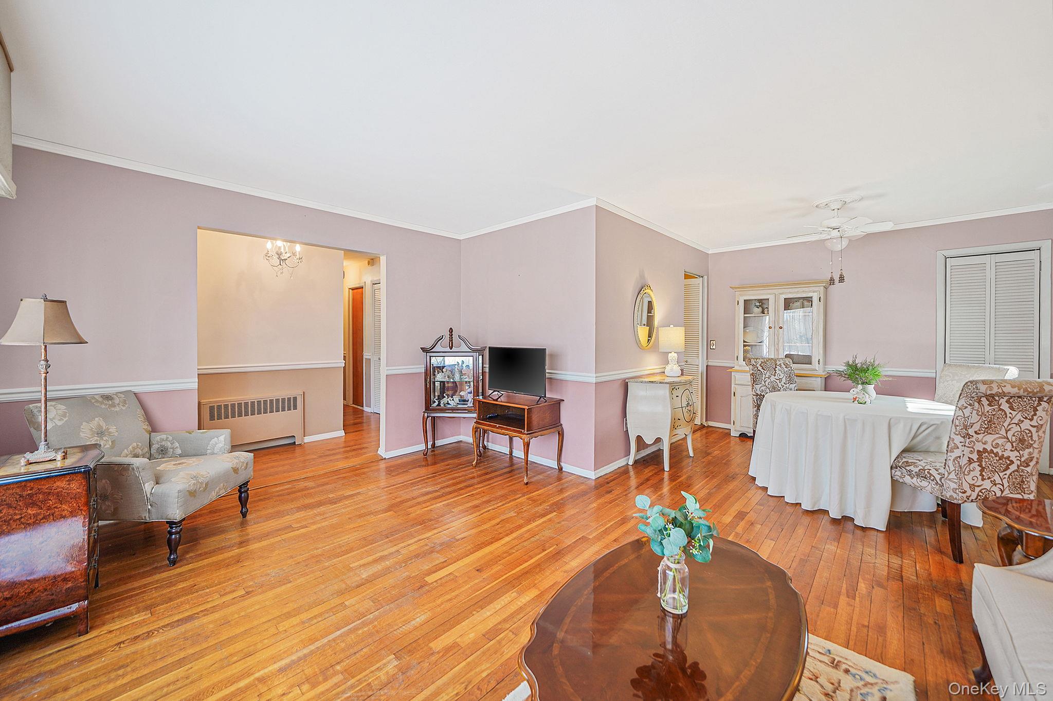 2009 Newbridge Road Bellmore, NY 11710 - Photo 10 of 24 a living room with furniture and a wooden floor