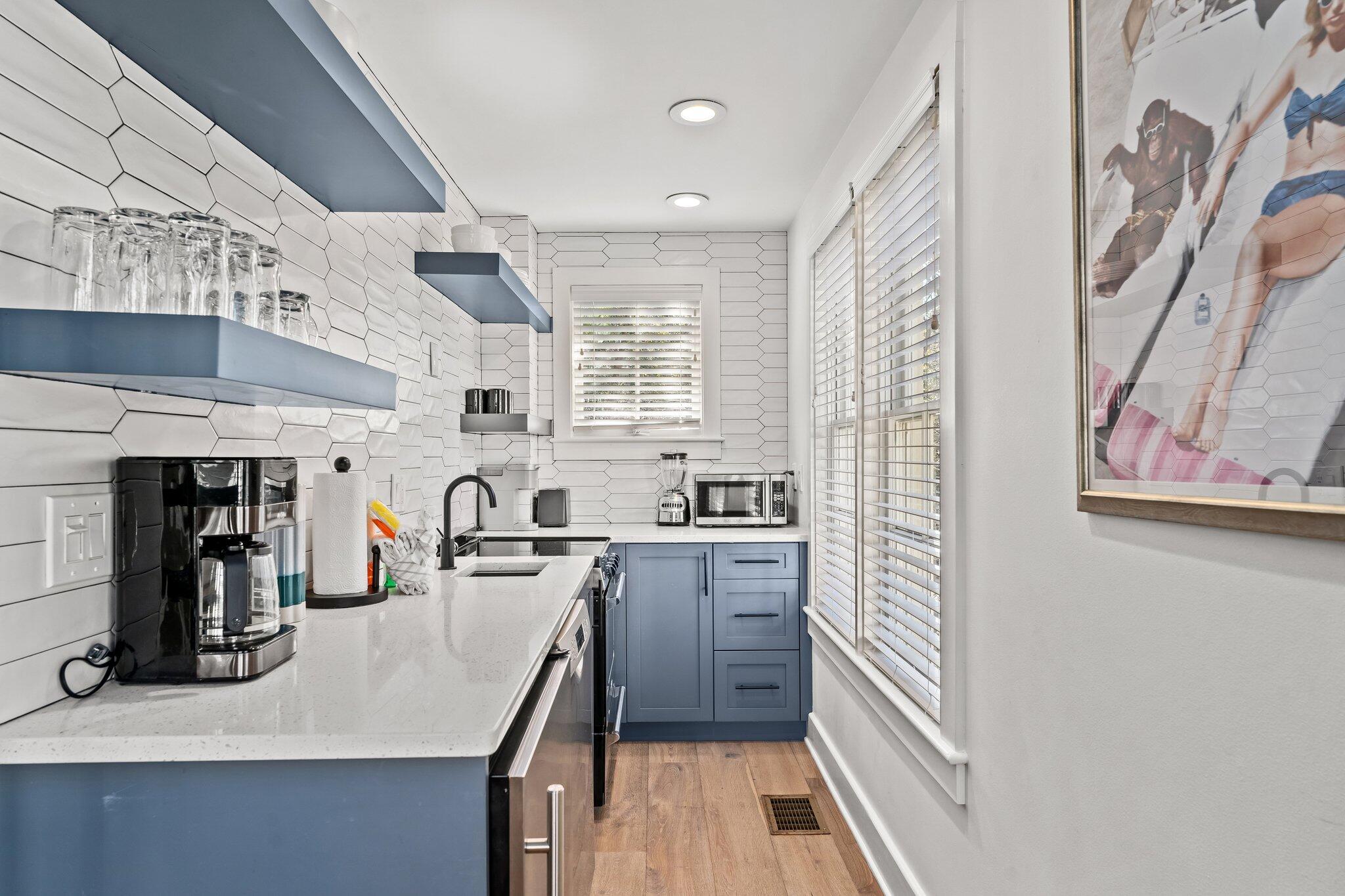 101 Round Road Rosemary Beach, FL 32461 - Photo 40 of 46 a kitchen with stainless steel appliances a sink a stove and cabinets