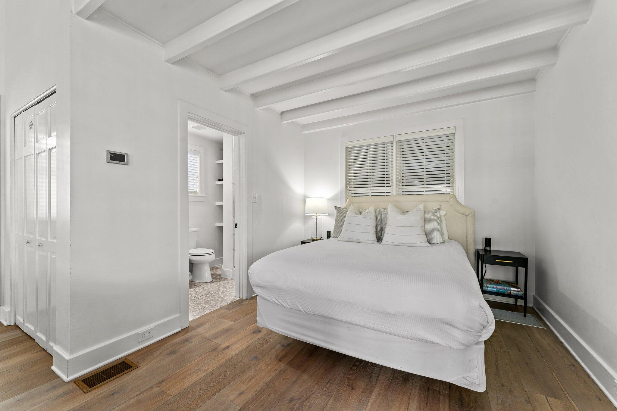 101 Round Road Rosemary Beach, FL 32461 - Photo 41 of 46 a bedroom with a bed and wooden floor