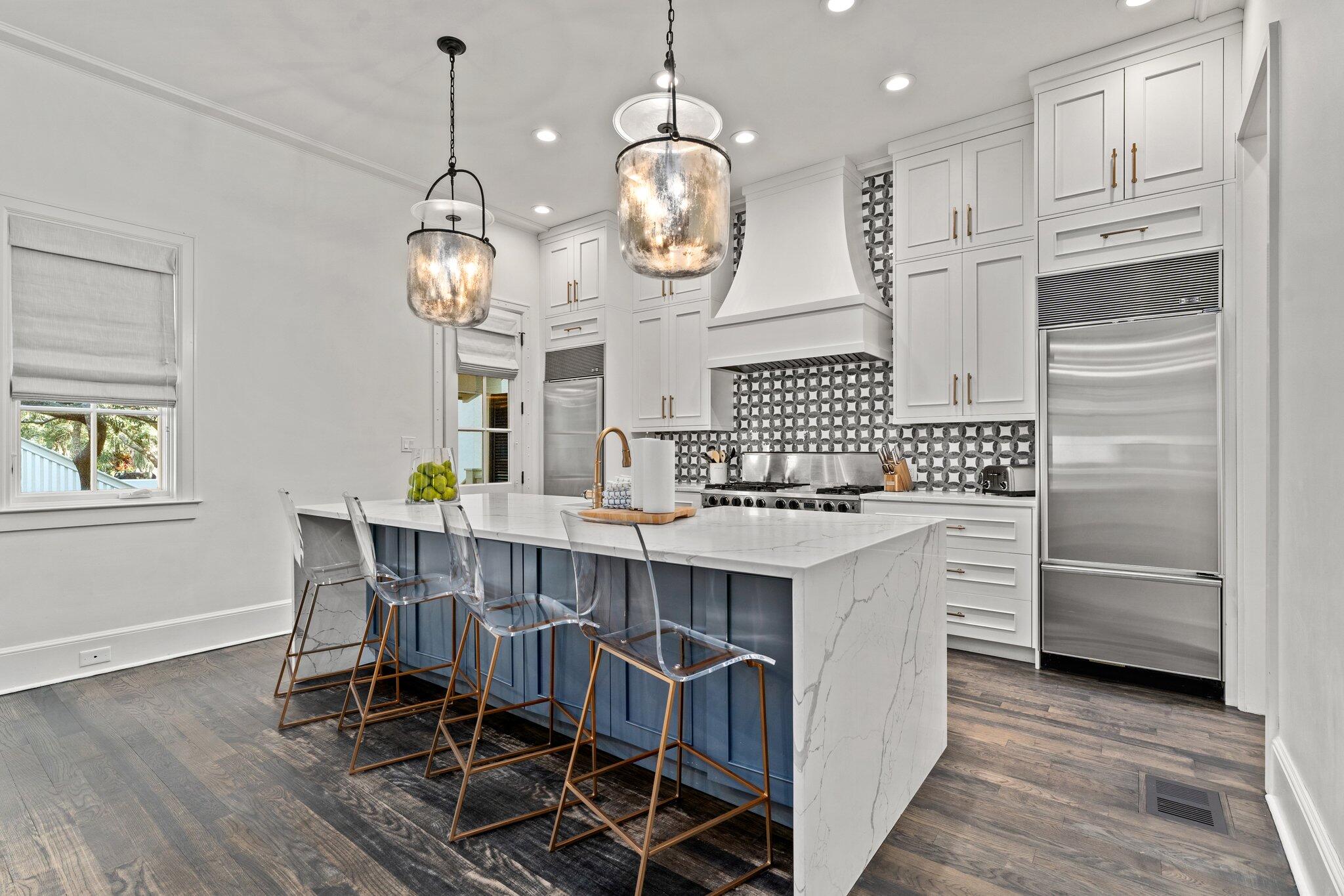 101 Round Road Rosemary Beach, FL 32461 - Photo 5 of 46 a kitchen with a dining table chairs cabinets and stainless steel appliances