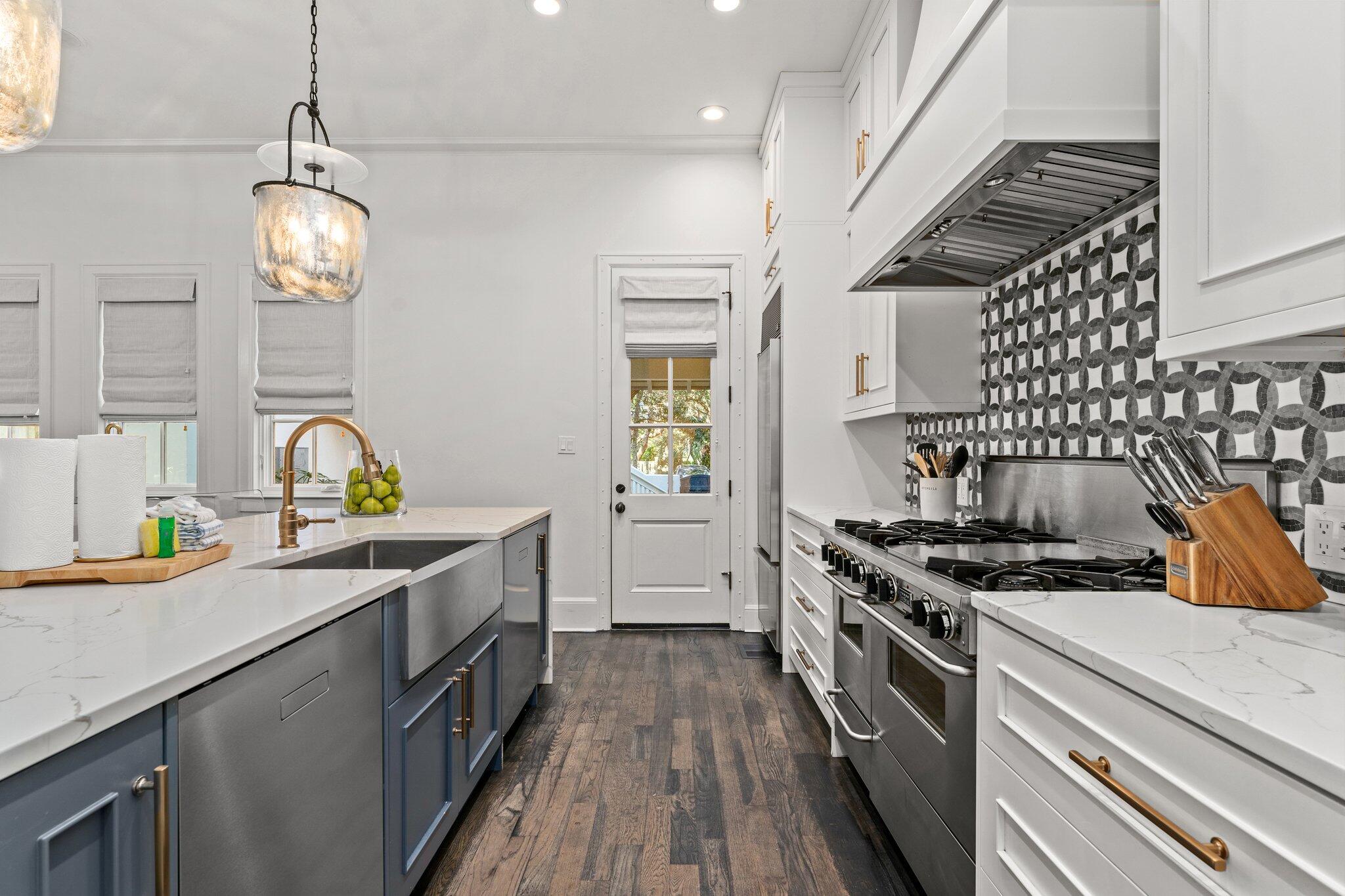 101 Round Road Rosemary Beach, FL 32461 - Photo 6 of 46 a kitchen with stainless steel appliances granite countertop a stove a sink dishwasher and a stove with wooden floor