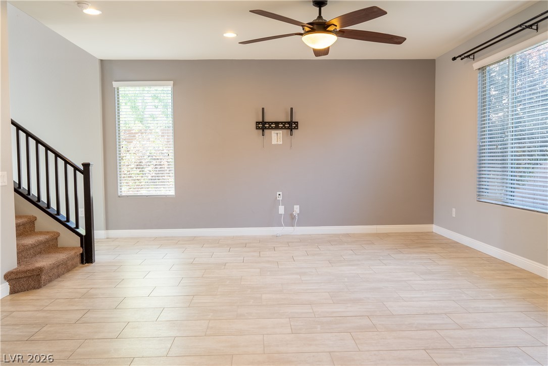 11045 Elk Sands Road Las Vegas, NV 89179 - Photo 52 of 67 An open living space features durable tile flooring, recessed lighting, and a staircase.