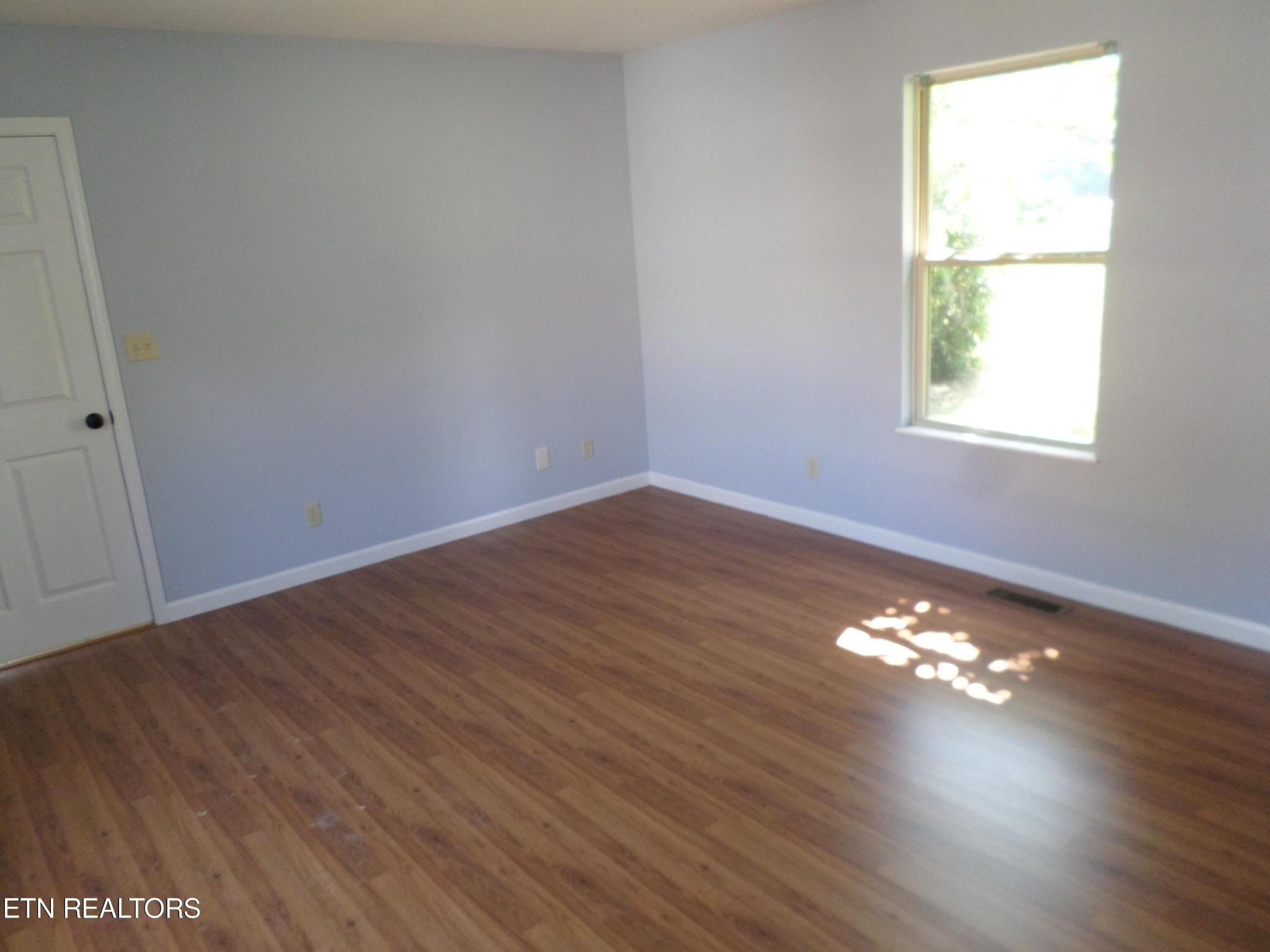 236 Woods Road Oliver Springs, TN 37840 - Photo 13 of 23 an empty room with wooden floor and windows