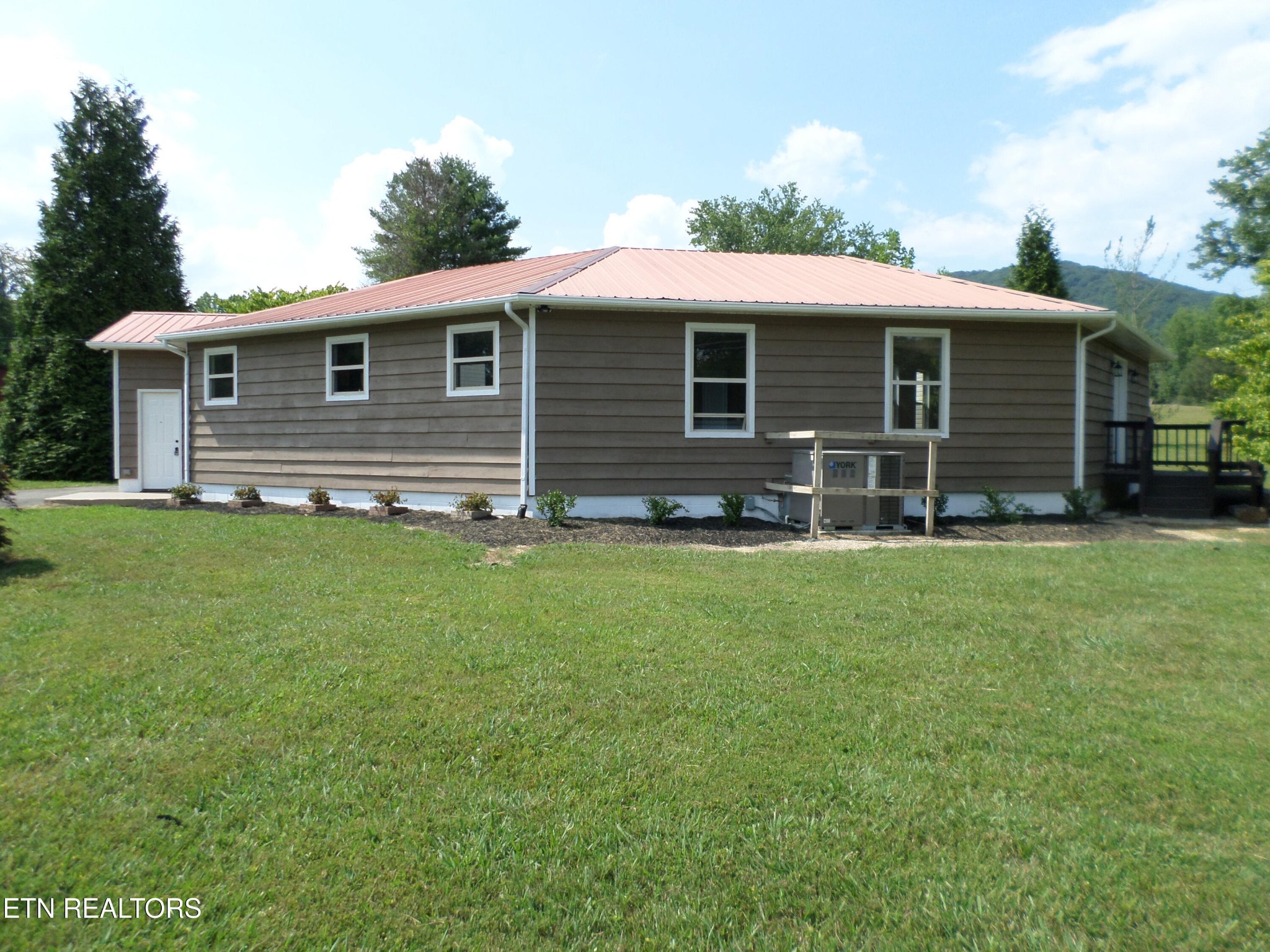 236 Woods Road Oliver Springs, TN 37840 - Photo 2 of 23 a front view of house with yard and trees in the background