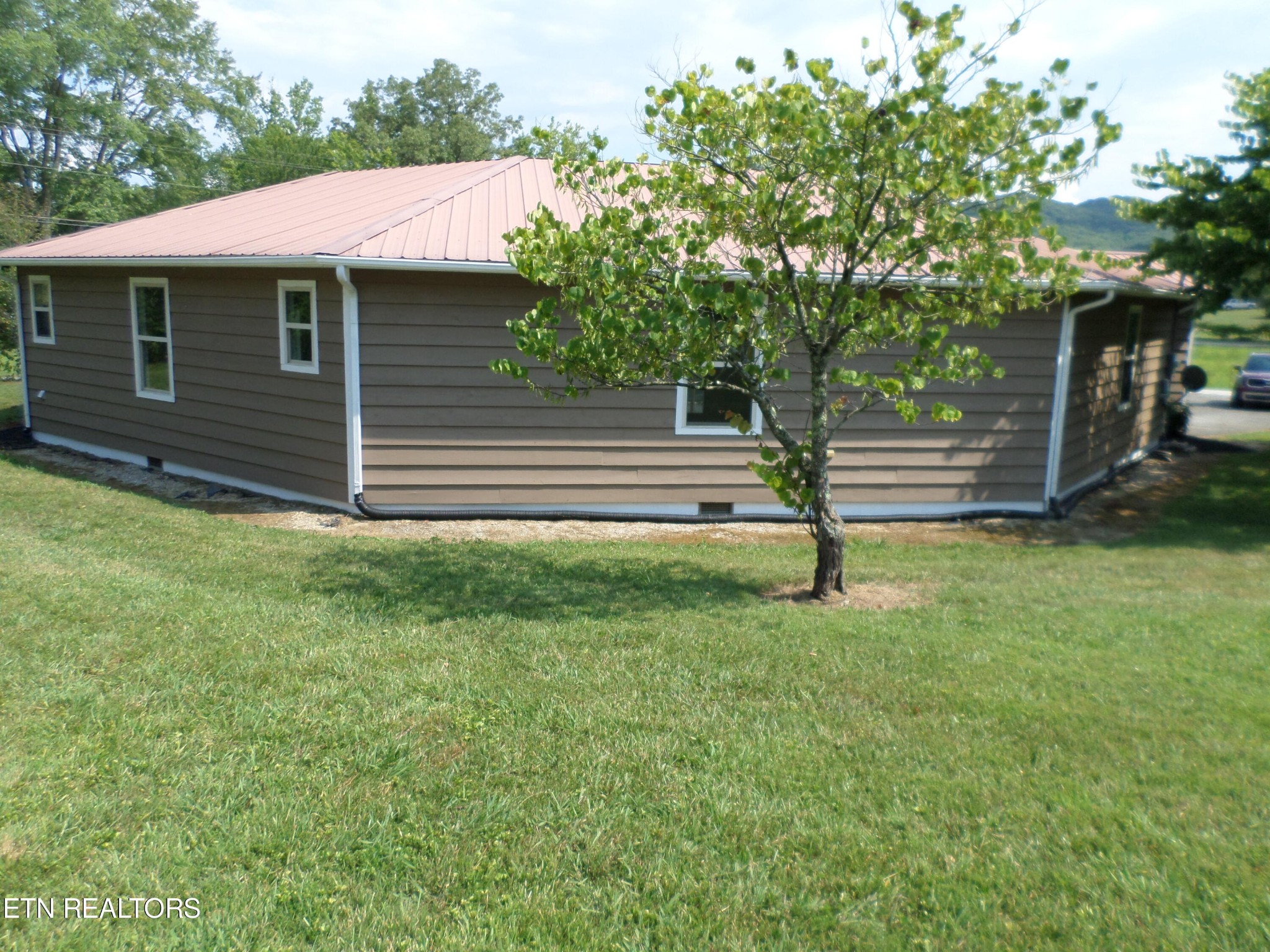 236 Woods Road Oliver Springs, TN 37840 - Photo 21 of 23 a front view of a house with garden
