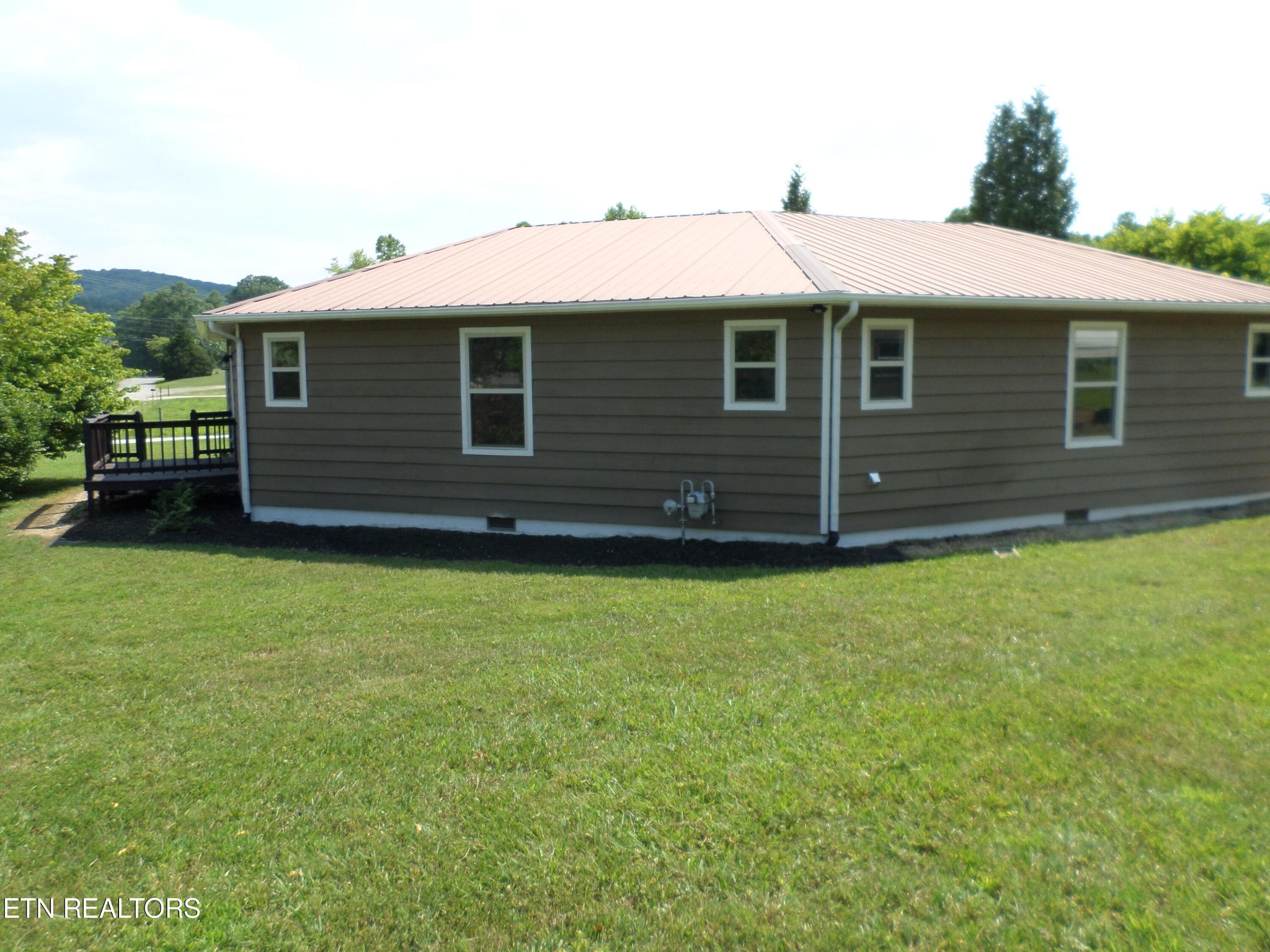 236 Woods Road Oliver Springs, TN 37840 - Photo 22 of 23 a front view of a house with a garden