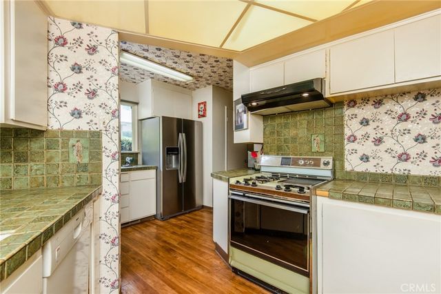 a kitchen with stainless steel appliances granite countertop a stove and a refrigerator