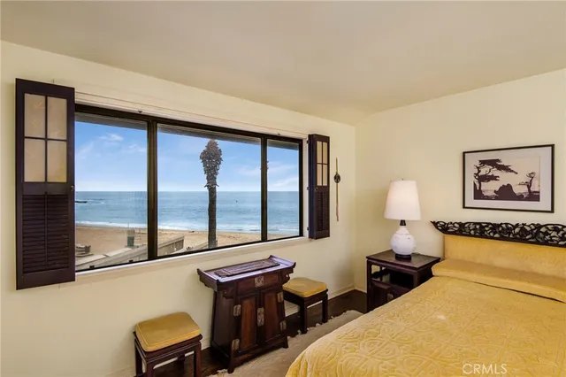 a bedroom with furniture and a large window