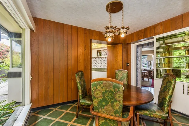 a view of a dining room with furniture and chandelier