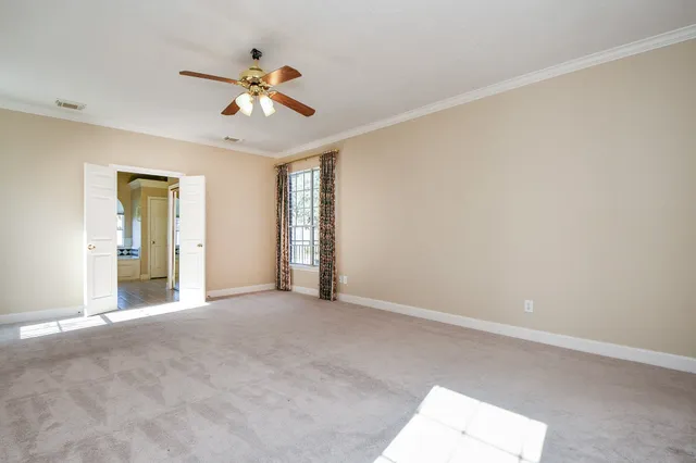a spacious en suite bathroom with a tub sink and mirror