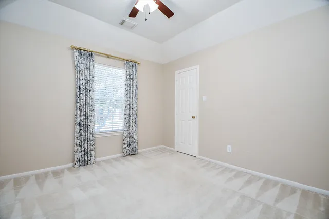 an empty room with closet and a window