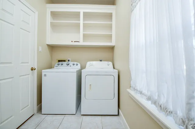 a front view of a house with a yard table and chairs