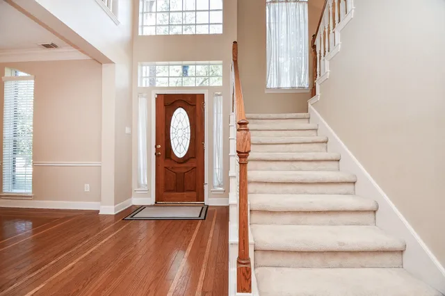 a view of a door with wooden floor and a window