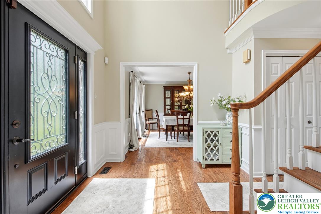 115 West Butternut Road Hellertown, PA 18055 - Photo 10 of 97 A welcoming entry hall boasts natural wood floors, leading guests into an inviting dining area.