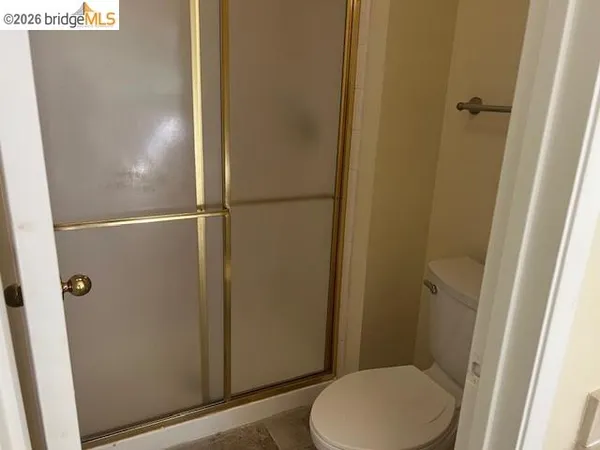 a bathroom with a toilet and a shower