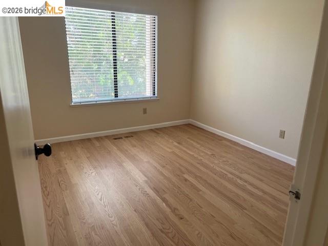 1445 Huston Road Walnut Creek, CA 94597 - Photo 4 of 12 an empty room with wooden floor and windows
